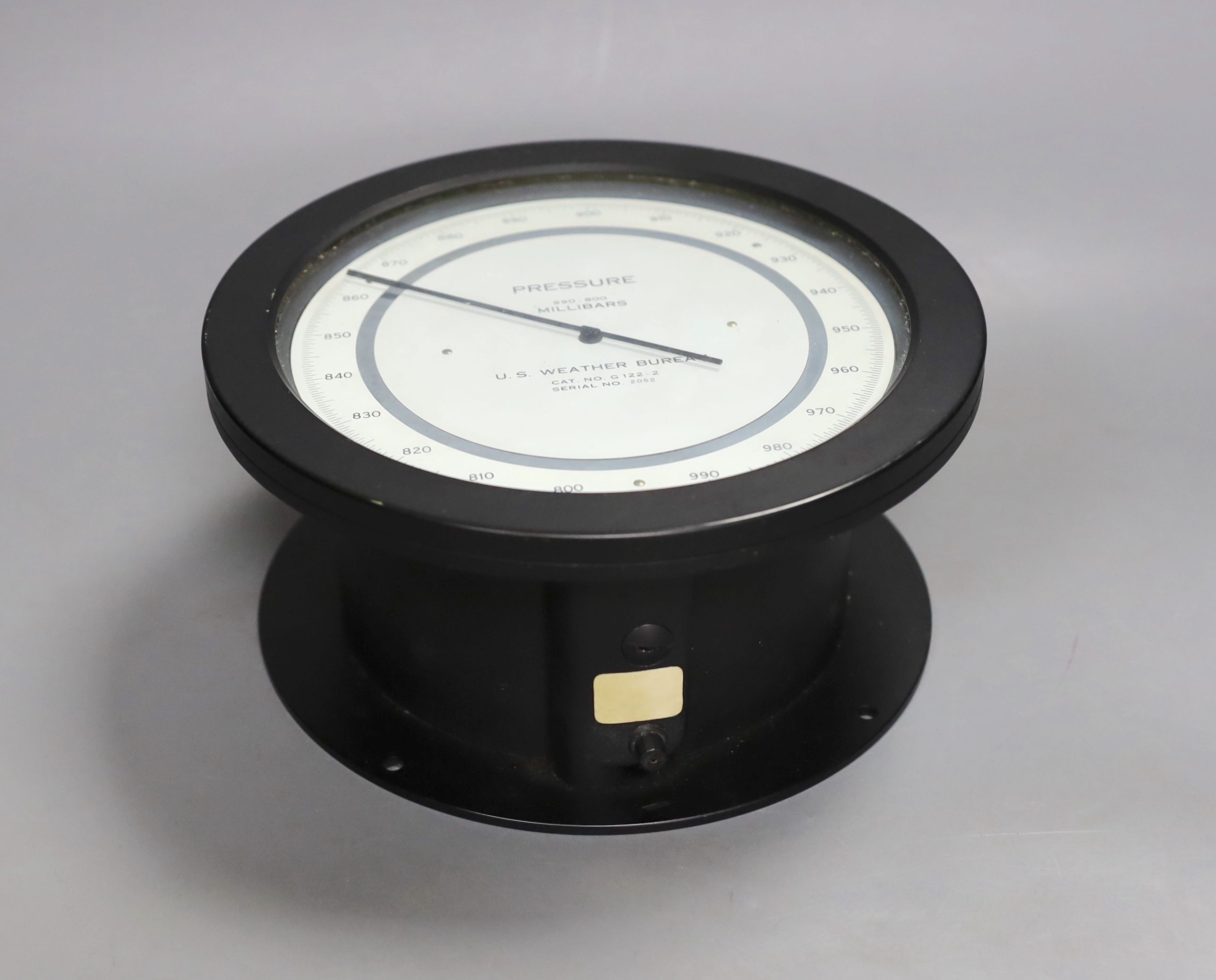 A U.S. Weather Bureau barometer , millibars 990-800, serial number 2052, 21 cms diameter.